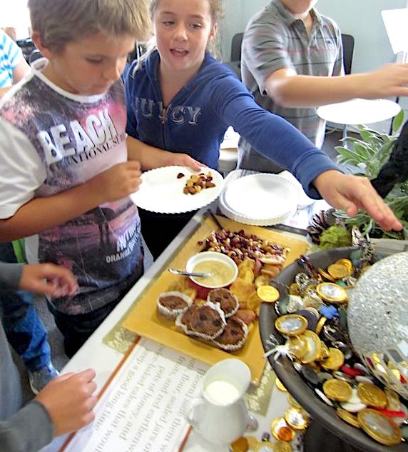 Kids serving up from a buffet of foods provided by Beorn in THE HOBBIT by JRR Tolkien - a teaching idea from LitWits Workshops
