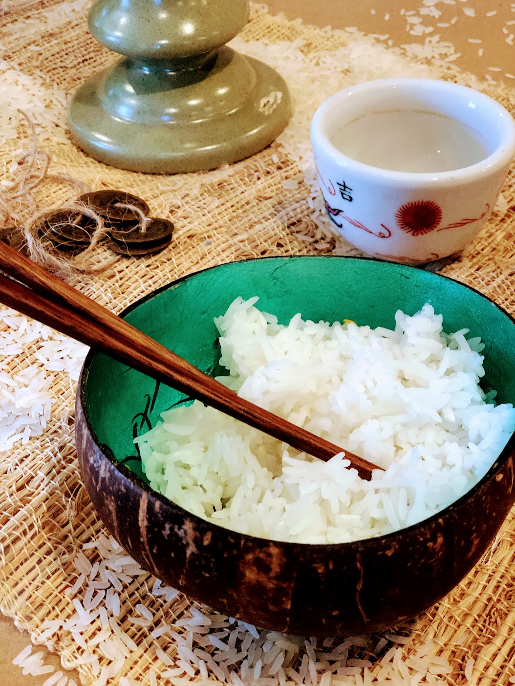 A bowl of rice and chopsticks, coins on a string, and a teacup - sensory props from A SINGLE SHARD by Linda Sue Park - LitWits Workshops