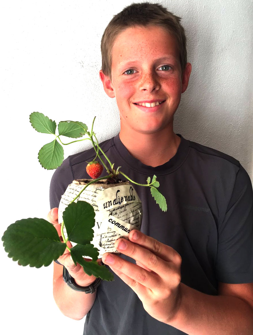 Student holding a goldfish bowl layered and filled with many thematic ideas from THE CIRCUIT by Francisco Jimenez - a creative teaching idea from LitWits Workshops
