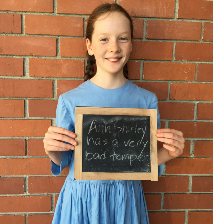 A modern Anne of Green Gables holding her handmade slate - a creative teaching idea from LitWits Workshops