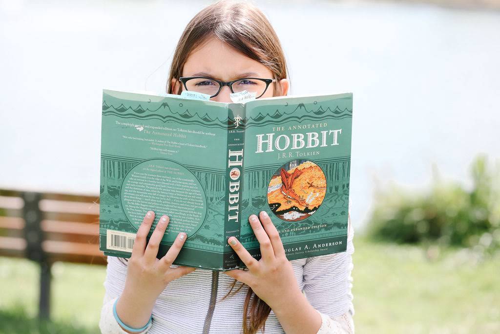 Child engaged in reading THE HOBBIT by JRR Tolkien - LitWits Workshops learning and teaching activities