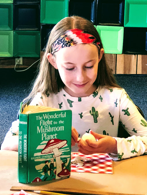 A girl eating a hard-boiled egg, which triggers the epiphany that saves The Mushroom Planet - a LitWits experience of THE WONDERFUL FLIGHT TO THE MUSHROOM PLANET by Eleanor Cameron
